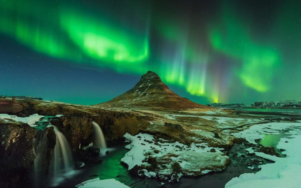 Northern lights in Iceland. A beautiful view with the land covered with ice and the sky glowing with the Northern lights.